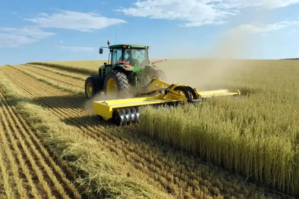 Tractor with disc mower cutting standing oats for hay