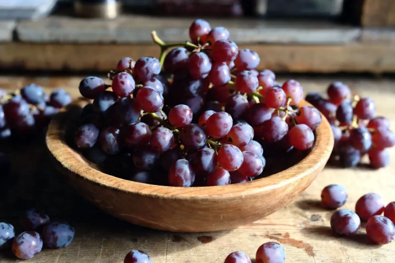 Bowl of dark red Candy Snap grapes on a kitchen counter showing the sweet table grape variety eaten as a healthy snack