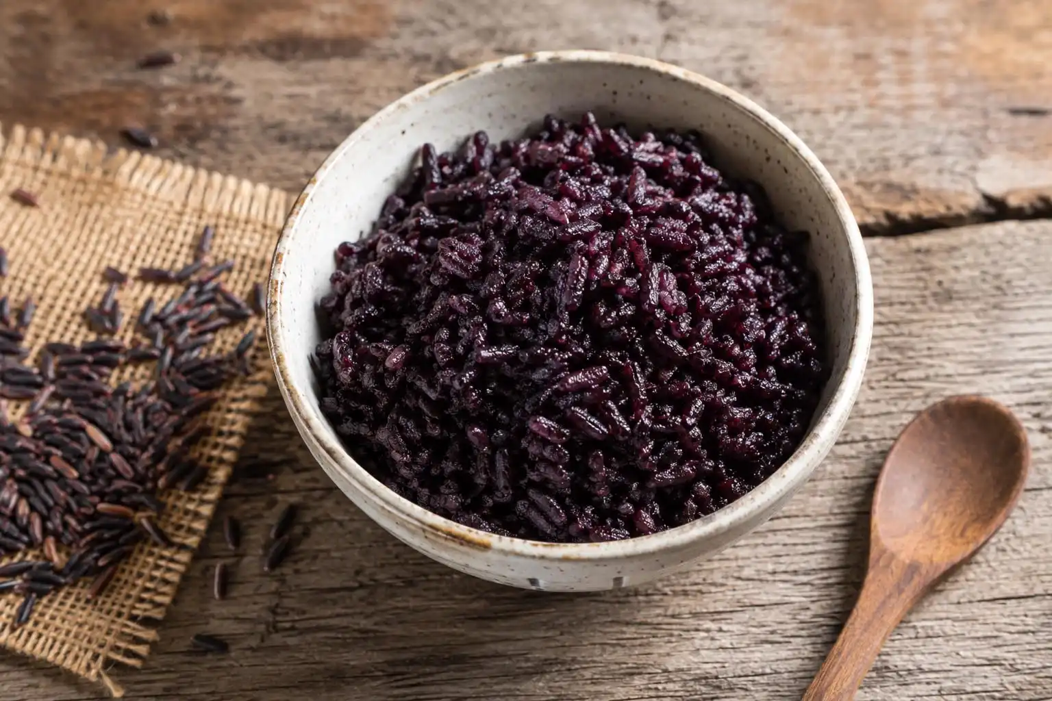 Bowl of cooked Jasberry rice on a farmhouse table