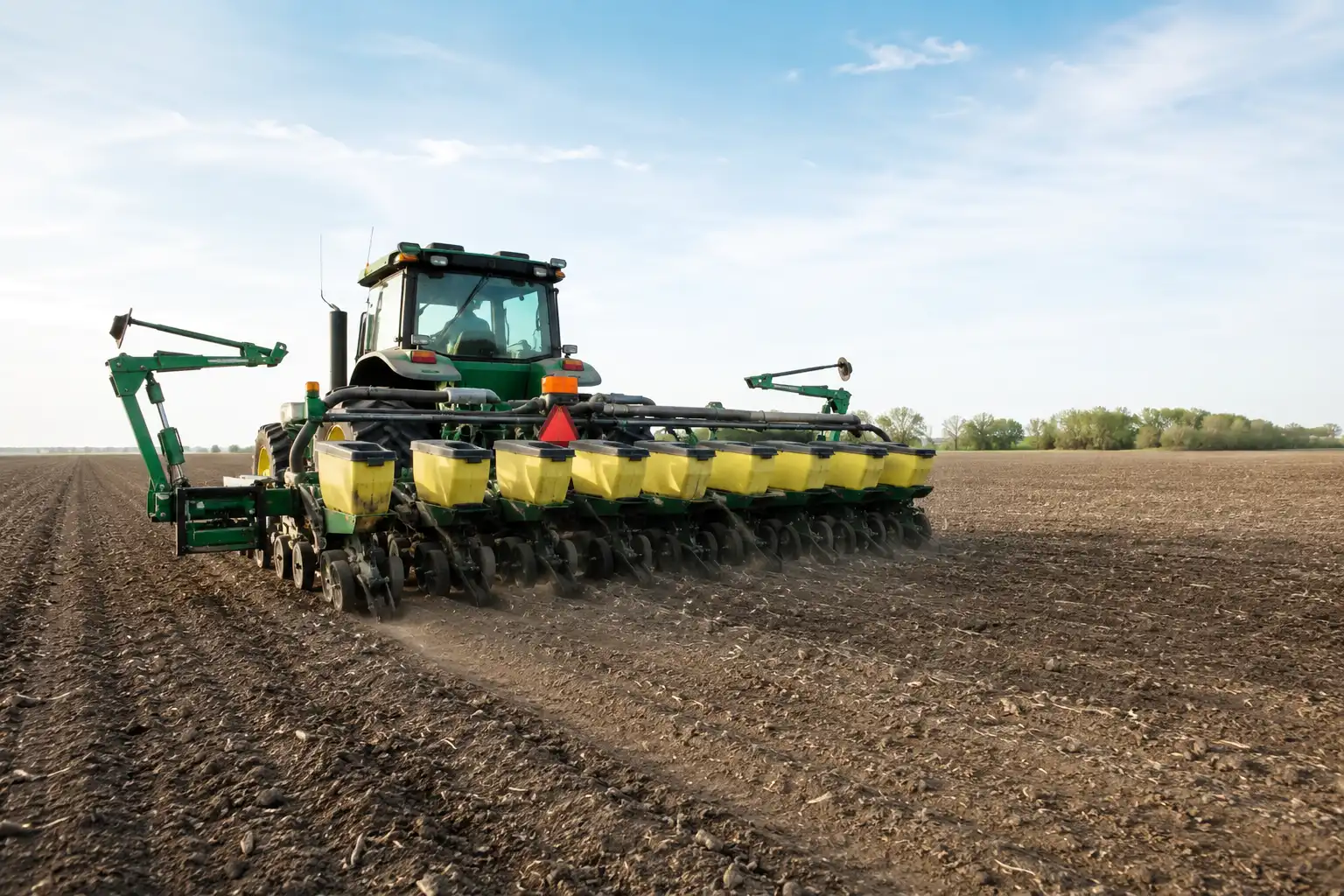 Corn planter applying DAP starter fertilizer band beside the seed row in a Kansas field at planting