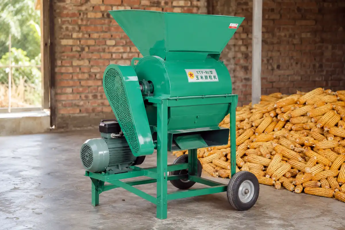 Electric corn sheller thresher with feeding hopper, motor, belt guard, and wheels